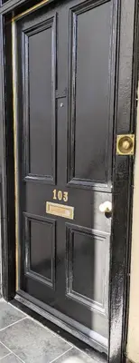 a black door with the number on it at Campbeltown Retreat in Campbeltown