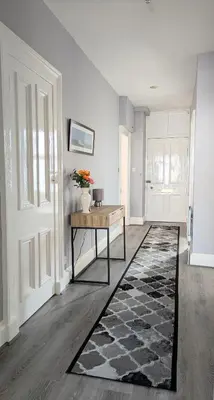 a living room with a table and a vase with flowers on it at Campbeltown Retreat in Campbeltown