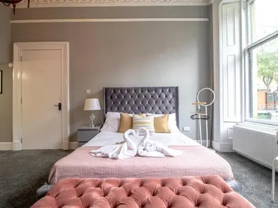a bedroom with a large bed with towels on it at Studio Dream with Loft West End - Pass the Keys in Glasgow