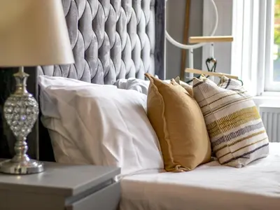 a bed with white pillows and a lamp on it at Studio Dream with Loft West End - Pass the Keys in Glasgow