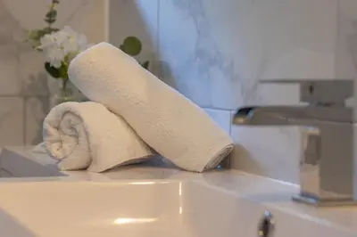 a roll of towels sitting on top of a bathroom sink at Cosy Palm Studio West End - Pass the Keys in Glasgow