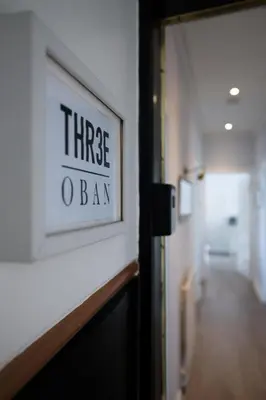 a sign that reads three loan on a wall in a hallway at Three Oban in Oban