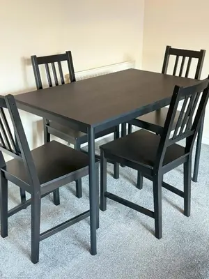 a black dining table and two black chairs at Kingfisher Apartment in Dunfermline