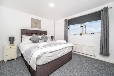 a bedroom with a large bed and a window at Pure Home Rosyth Dockyard by TBA in Rosyth