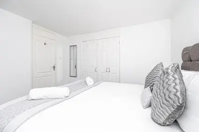 a white bedroom with a large white bed at Pure Home Rosyth Dockyard by TBA in Rosyth