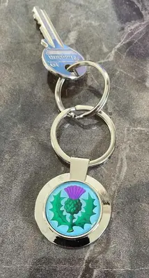 a key chain with a flower on it at Thistle Lodge in Dollar