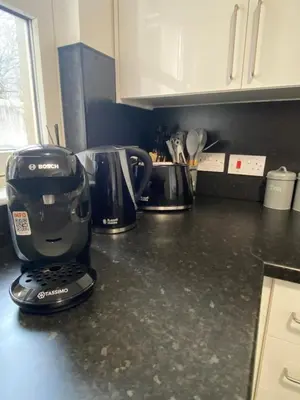 a kitchen counter with a coffee maker on it at Prime City Centre - Ground Floor Parking by TBA in Dunfermline
