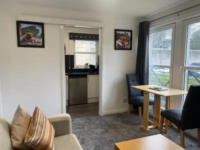 a living room with a couch and a table at Prime City Centre - Ground Floor Parking by TBA in Dunfermline