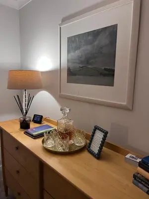 a desk with a lamp and a glass jar on it at Castle View Retreat in Edinburgh