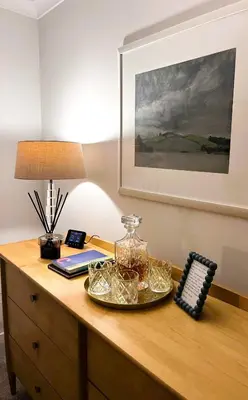 a desk with a lamp and a glass jar on it at Castle View Retreat in Edinburgh