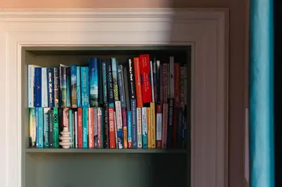 a book shelf filled with lots of books at Beautiful central Edinburgh Apartment in Edinburgh
