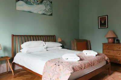 a bedroom with a bed with two towels on it at Beautiful central Edinburgh Apartment in Edinburgh