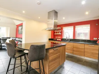 a kitchen with a table and chairs in a room at Taighean Anndra in Killin