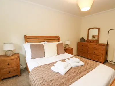 a bedroom with a bed with towels on it at Taighean Anndra in Killin