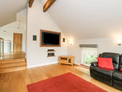 a living room with a couch and a tv at Taighean Anndra in Killin