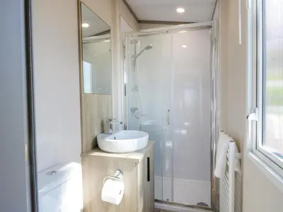 a bathroom with a white sink and a shower at 11A Mansion View in Helensburgh