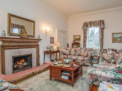 a living room with a fireplace and couches at Country Home on Private Estate in Minishant