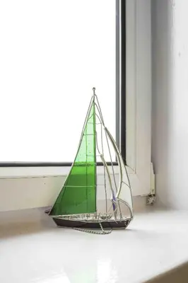 a small green sail boat sitting on a window sill at Blackness Apartment in Linlithgow
