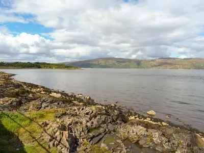 a large body of water with mountains in the background at Lodge 5 - 