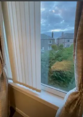 a window with a view of a yard at Room in a Home in Edinburgh
