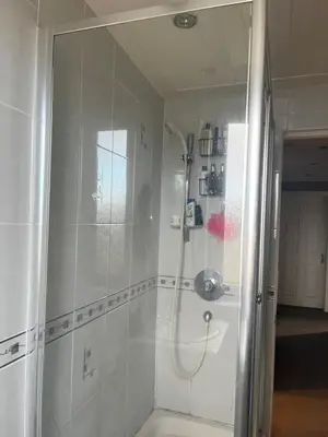 a bathroom with a shower and a sink at Room in a Home in Edinburgh