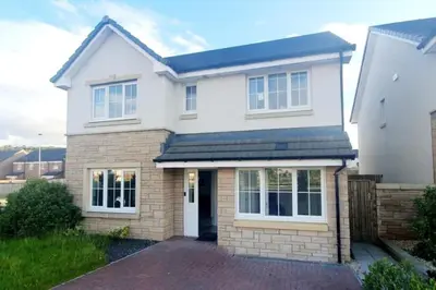 a white house with a brick driveway at Entire 4 bed perfect family home in Glasgow in Nitshill