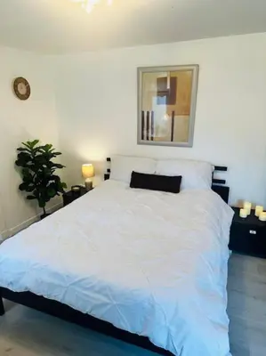 a bedroom with a white bed with a black pillow at Entire Private 1 Bedroom - Guest Suite in Glasgow in Glasgow