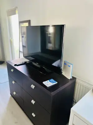 a dresser with a large tv on top of it at Entire Private 1 Bedroom - Guest Suite in Glasgow in Glasgow