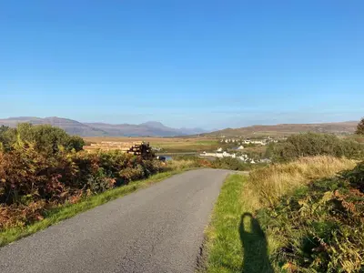 a shadow of a person standing on a road at Cottage-IsleofMull-StunningViews-WiFi-Parking in Bunessan