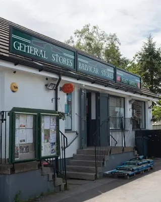 a building with a sign for a grocery store at Countryside Farm Pod on Isle of Seil - A in Balvicar