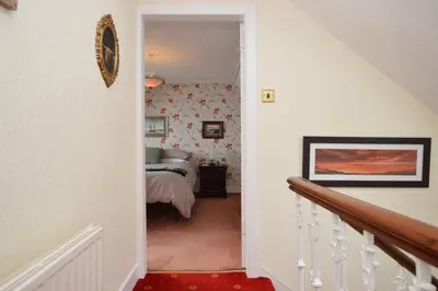 a hallway leading to a bedroom with a bed at St Abbs in Innellan