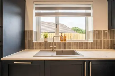a kitchen counter with a sink and a window at Cottage with Hot Tub near Knockhill in Saline