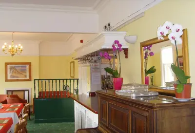 a room with a counter with flowers on it at Twin Lions Hotel in Edinburgh