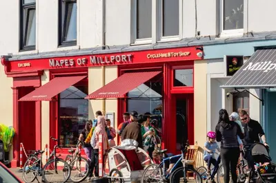 a group of people standing outside of a store at Fairview Millport in Millport