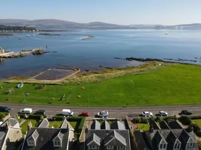 an aerial view of a large body of water with houses at Fairview Millport in Millport