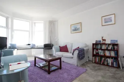 a living room with a couch and a table at Fairview Millport in Millport