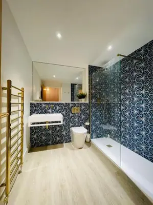 a bathroom with a shower and a toilet and a sink at Designer Studio in Edinburgh with Free Parking in Edinburgh