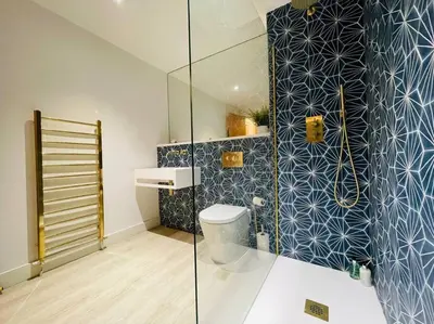 a bathroom with a toilet and a glass shower at Designer Studio in Edinburgh with Free Parking in Edinburgh