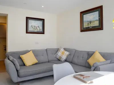 a living room with a gray couch with yellow pillows at Oak -Apartment 4 in Aberfoyle