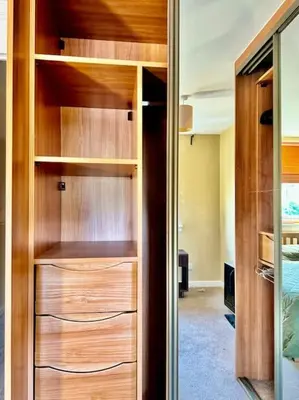 a closet with wooden shelves in a room at Two bedroom maisonette in the heart of the West End in Glasgow