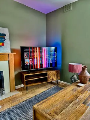 a living room with a large flat screen tv at Two bedroom maisonette in the heart of the West End in Glasgow