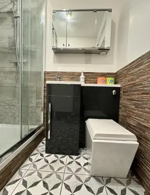 a bathroom with a toilet and a sink and a shower at Two bedroom maisonette in the heart of the West End in Glasgow