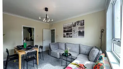 a living room with a couch and a table at Colourful life-house near Glasgow in Clydebank