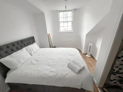 a bedroom with a large white bed with a window at Edinburgh elms for 4 - New Town - City Center EB8 in Edinburgh