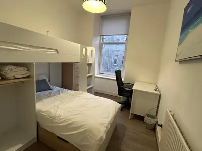 a small bedroom with a bunk bed and a desk at 2B apartment near Glasgow SEC, OVO Hydro & city centre in Glasgow