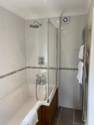 a bathroom with a bath tub and a shower at 1 Inveravon Cottage in Falkirk