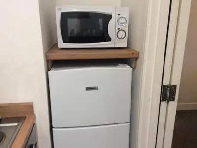a microwave sitting on top of a refrigerator at 103 NELSON STREET Aubery in Largs