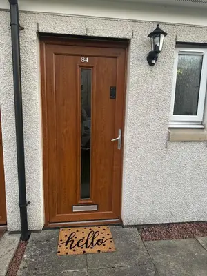 a wooden door with a sign in front of it at Black Daisy in Glasgow