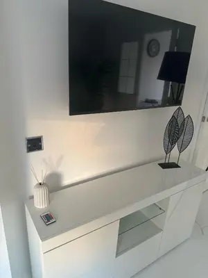 a white dresser with a mirror on top of it at Black Daisy in Glasgow