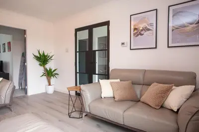 a living room with a couch and a table at Modern 3 Bed Flat Balloch in Jamestown